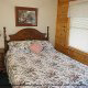 Country charm describes this quaint bedroom in cabin 77  (Dakotas Bird House), in Pigeon Forge, Tennessee. 