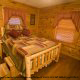 Climb into this inviting bed and snuggle in for a deep sleep in this country bedroom   in cabin 79 (Robyns Nest), in Pigeon Forge, Tennessee.