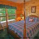 This bedroom is so alluring with its four poster bed in cabin 80 (Heavenly Haven), in Pigeon Forge, Tennessee.