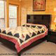 Bedroom with Queen Size Bed in Cabin 816 (Almost Paradise) at Eagles Ridge Resort at Pigeon Forge, Tennessee.