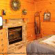 Bedroom View with Fire Place of Cabin 82 (The Wolves Den) at Eagles Ridge Resort at Pigeon Forge, Tennessee.