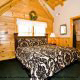 Enjoy the charming large bedroom in cabin 83 (Sweet Serenity), in Pigeon Forge, Tennessee.