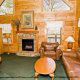 This open living room has a fire place to make it feel cozy on a cool evening in cabin 83 (Sweet Serenity), in Pigeon 