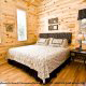 Bedroom View with Night Stand - Cabin 834 (Lakeside Getaway) at Eagles Ridge Resort at Pigeon Forge, Tennessee.