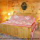 Country Bedroom View of Cabin 844 (Bear Claw Lodge) at Eagles Ridge Resort at Pigeon Forge, Tennessee.