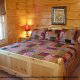 Bedroom with King Size Bed in Cabin 849 (Sweet Escape) at Eagles Ridge Resort at Pigeon Forge, Tennessee.