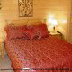 Bedroom with Two Night Stands in Cabin 850 (Simply The Best) at Eagles Ridge Resort at Pigeon Forge, Tennessee.