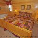 Country bedroom in cabin 859 (Absolute Paradise) , in Pigeon Forge, Tennessee.