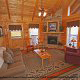 Living room with fireplace in cabin 859 (Absolute Paradise) , in Pigeon Forge, Tennessee.