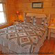 Country bedroom in cabin 864 (The Cedars) at Eagles Ridge Resort at Pigeon Forge, Tennessee.