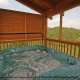 Outdoor deck with hot tub in cabin 864 (The Cedars) at Eagles Ridge Resort at Pigeon Forge, Tennessee.
