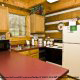 Kitchen View with Refrigerator of Cabin 87 (Cozy Timbers) at Eagles Ridge Resort at Pigeon Forge, Tennessee.
