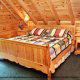 Bedroom View with two Night Stands in Cabin 93 (Pirates Cove) at Eagles Ridge Resort at Pigeon Forge, Tennessee.