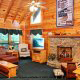 Living Room View with Fire Place in Cabin 93 (Pirates Cove) at Eagles Ridge Resort at Pigeon Forge, Tennessee.