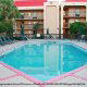Outdoor Pool with Chaise Lounge Chairs at the Hampton Inn Hotel in Gulfport, near Biloxi, Mississippi. Take the plunge and feel like a child again during your Halloween Vacation Getaway.
