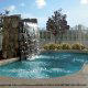 Outdoor Pool with Decorative Water Fall at Country Inn & Suites in Cocoa Beach, Florida.