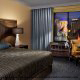 Bedroom View with King Size Bed - Excalibur Hotel and Casino in Las Vegas, Nevada. Affordable Vegas vacation packages now available at Rooms101.com.