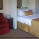 Queen size bed and suite at The Suites At Fall Creek in Branson Missouri.