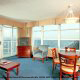Large living room with walls of glass to overlook the ocean at The Best Western Carolinian in Myrtle Beach