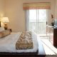 Valentines Day, all inclusive Orlando vacations starting at under $100.  Large king size bed with a balcony at the Palisades Resort in Orlando, Florida.