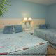 Double beds of a 1 bedroom condo in tropical pastel colors at the Star Island Resort and Club in Orlando Florida.