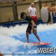 Kids having fun surfing in the wave pool at the Wilderness Stone Hill Lodge in Pigeon Forge Tennessee.