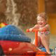 Toddler enjoys cooling off in water park at the Wilderness Stone Hill Lodge in Pigeon Forge Tennessee.